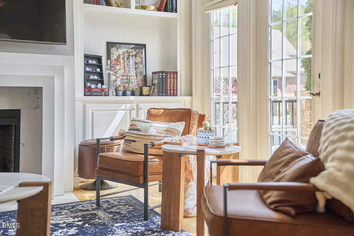 203 Valleyshire Road Durham, NC 27707 - Photo 10 of 37 a living room with furniture a window and a fireplace