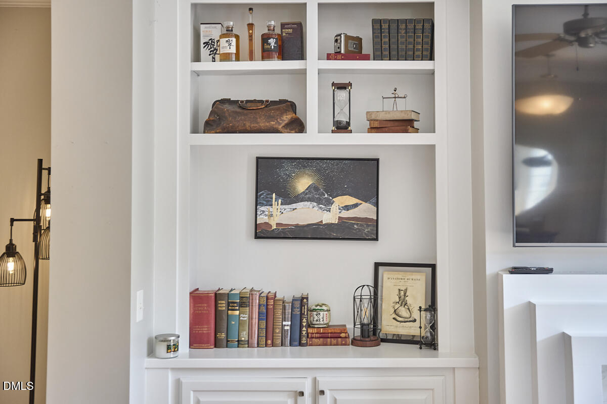 203 Valleyshire Road Durham, NC 27707 - Photo 11 of 37 a cabinet with painting on the wall and a shelf