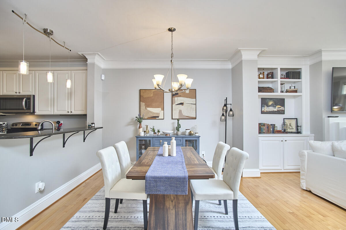 203 Valleyshire Road Durham, NC 27707 - Photo 16 of 37 a view of a dining room with furniture a rug and wooden floor