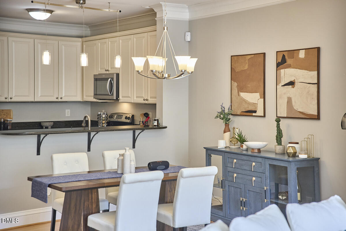 203 Valleyshire Road Durham, NC 27707 - Photo 17 of 37 a kitchen with a table chairs sink and cabinets
