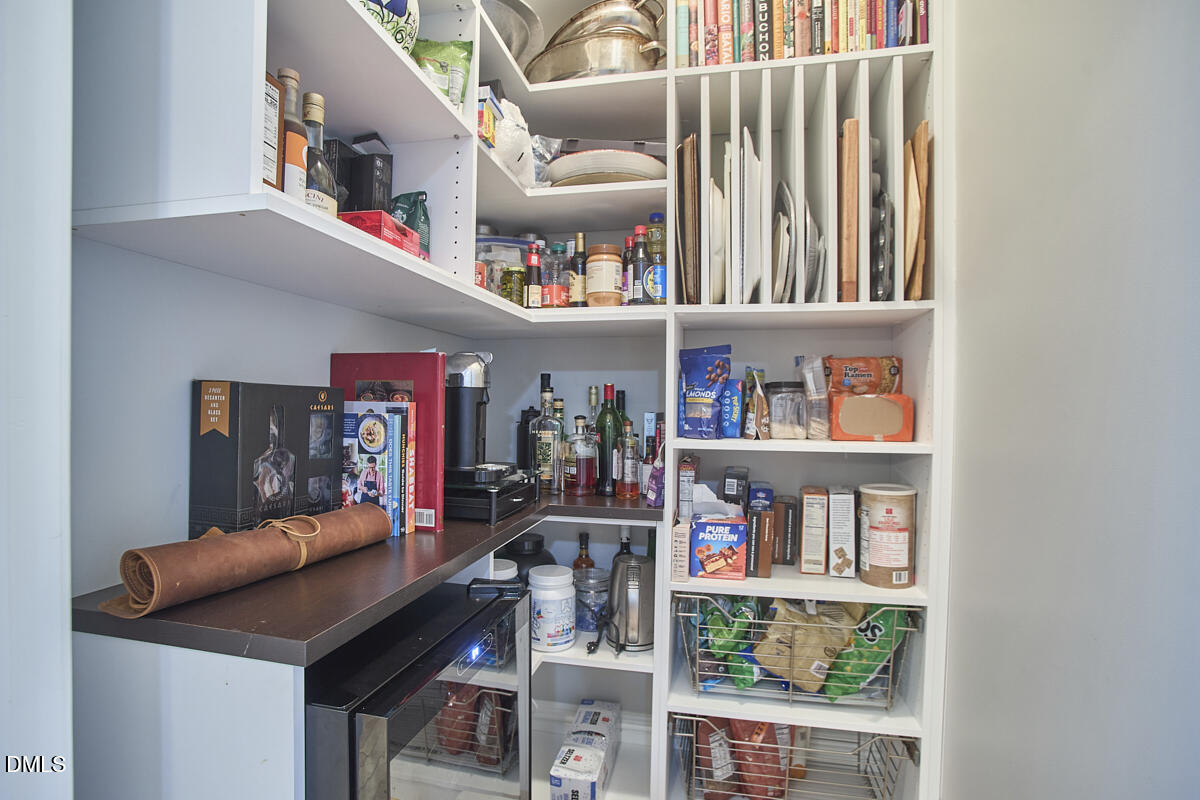 203 Valleyshire Road Durham, NC 27707 - Photo 22 of 37 a room with furniture and a book shelf