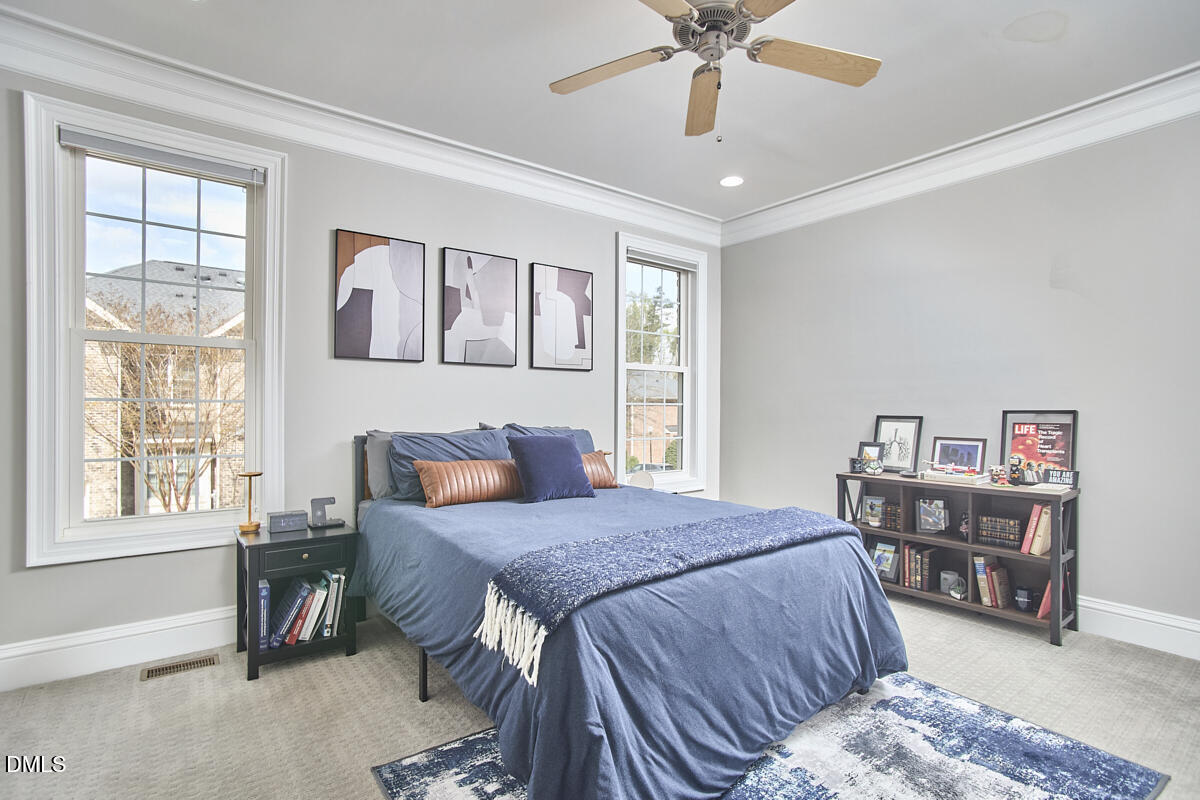 203 Valleyshire Road Durham, NC 27707 - Photo 23 of 37 a bedroom with a bed a dresser and a large window