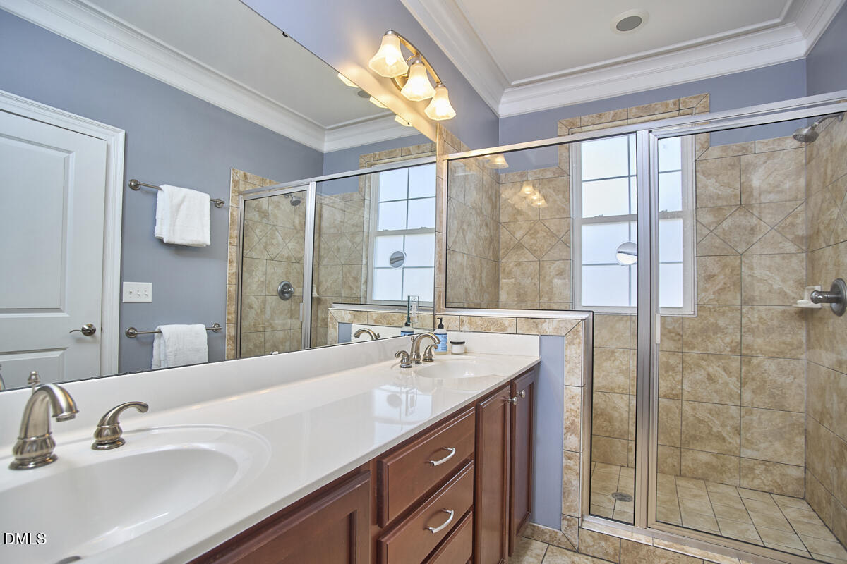 203 Valleyshire Road Durham, NC 27707 - Photo 25 of 37 a bathroom with a double vanity sink and a mirror