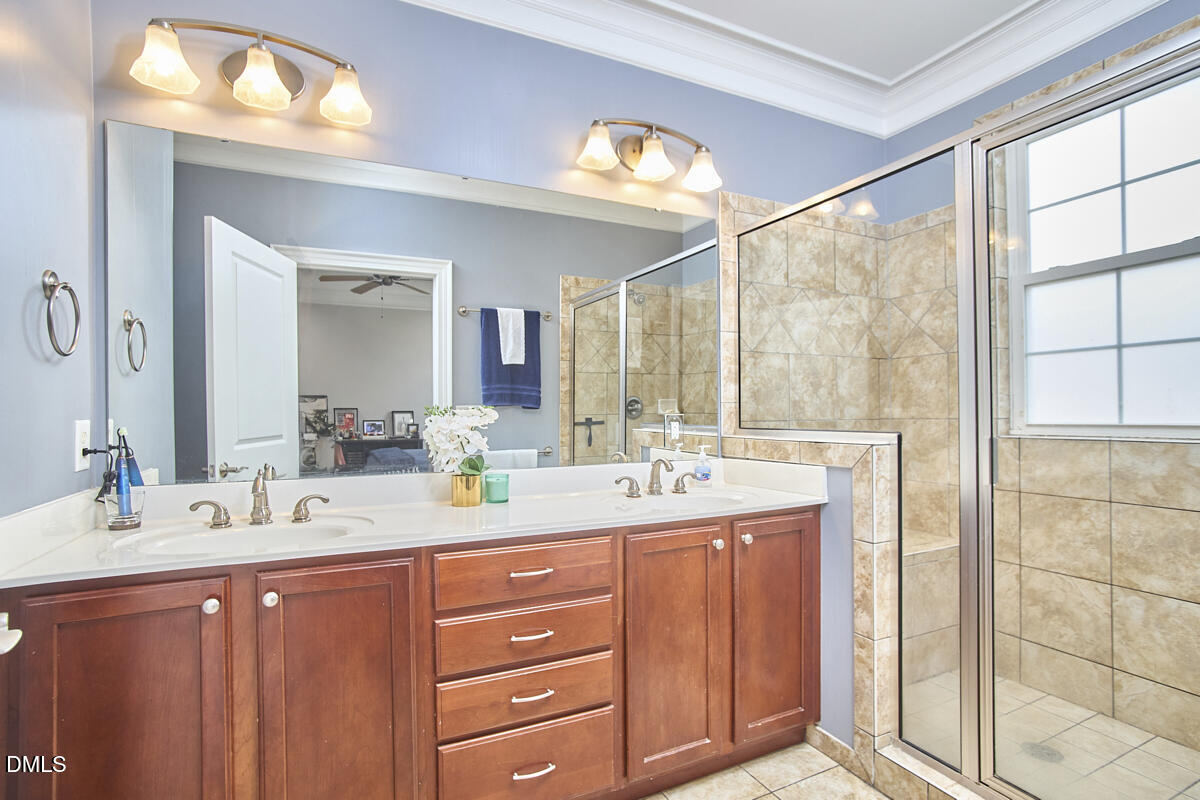 203 Valleyshire Road Durham, NC 27707 - Photo 26 of 37 a bathroom with a double vanity sink and a mirror