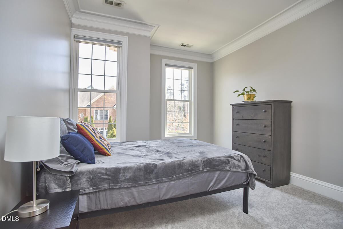 203 Valleyshire Road Durham, NC 27707 - Photo 27 of 37 a bedroom with a bed and a window