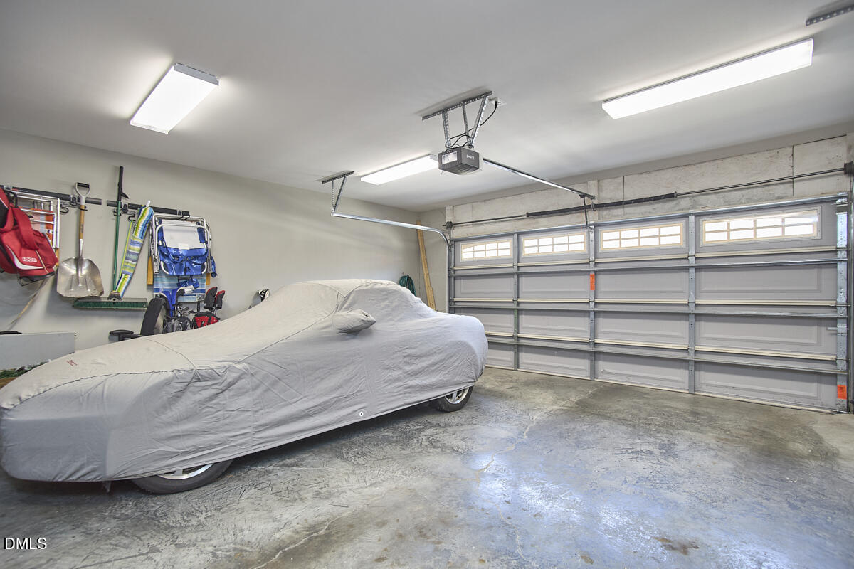 203 Valleyshire Road Durham, NC 27707 - Photo 34 of 37 a bedroom with a bed and a chandelier