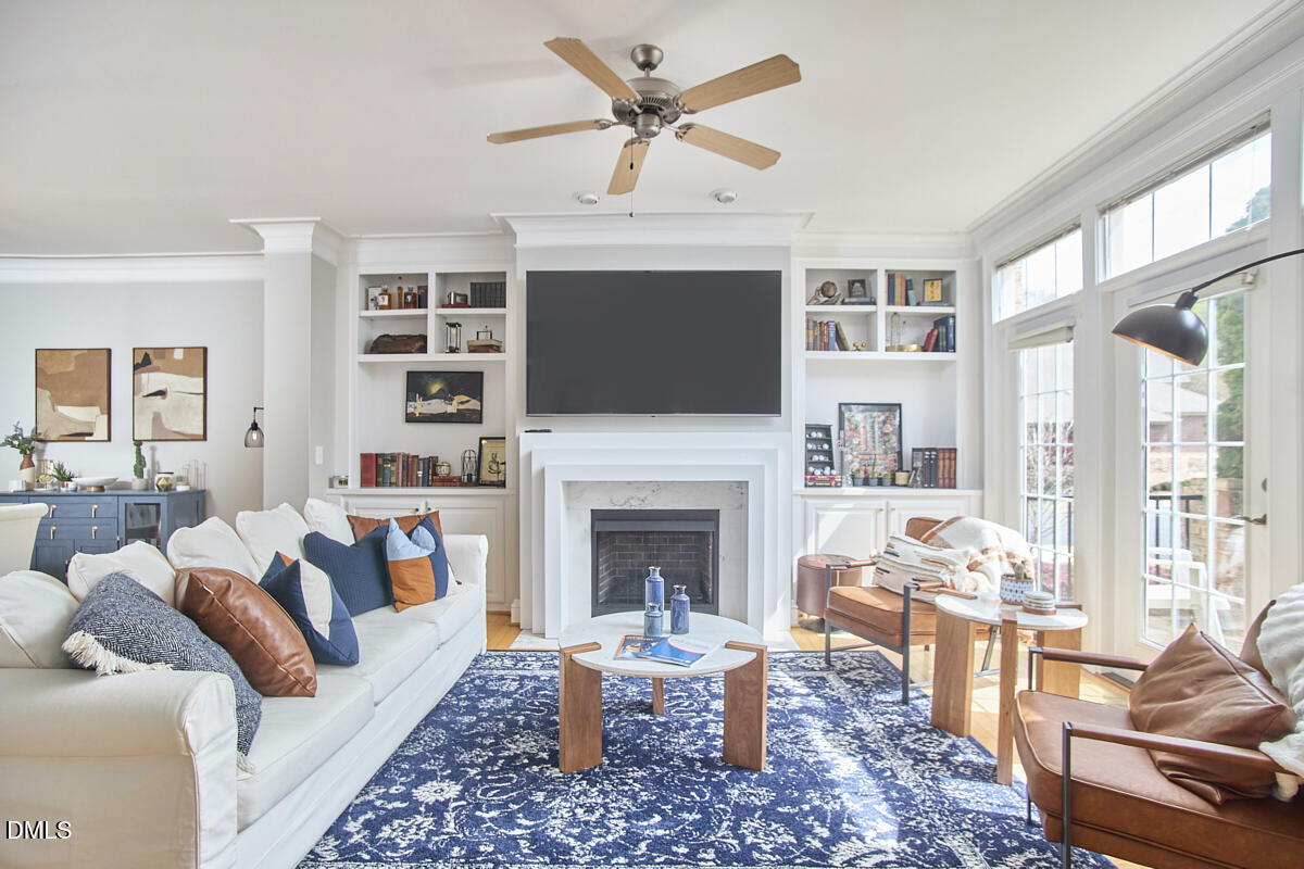 203 Valleyshire Road Durham, NC 27707 - Photo 7 of 37 a living room with furniture a fireplace and a flat screen tv