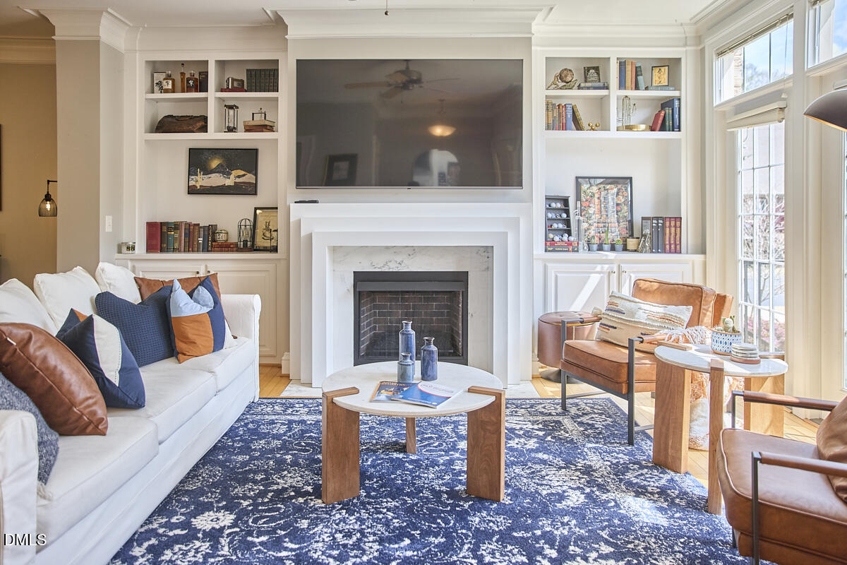 203 Valleyshire Road Durham, NC 27707 - Photo 8 of 37 a living room with furniture a flat screen tv and a fireplace