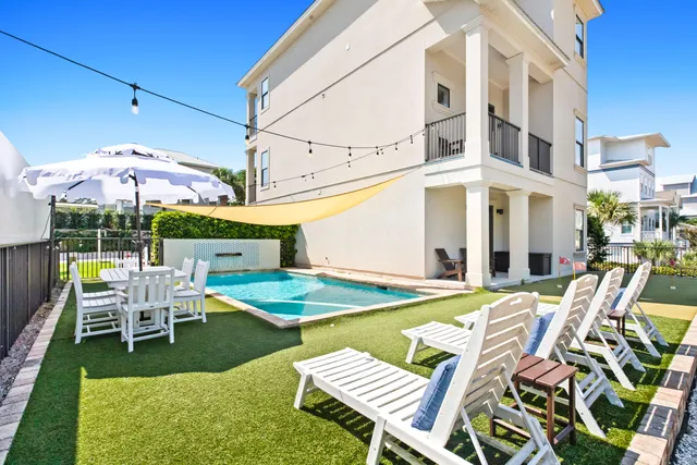 a view of a patio with a table and chairs under an umbrella