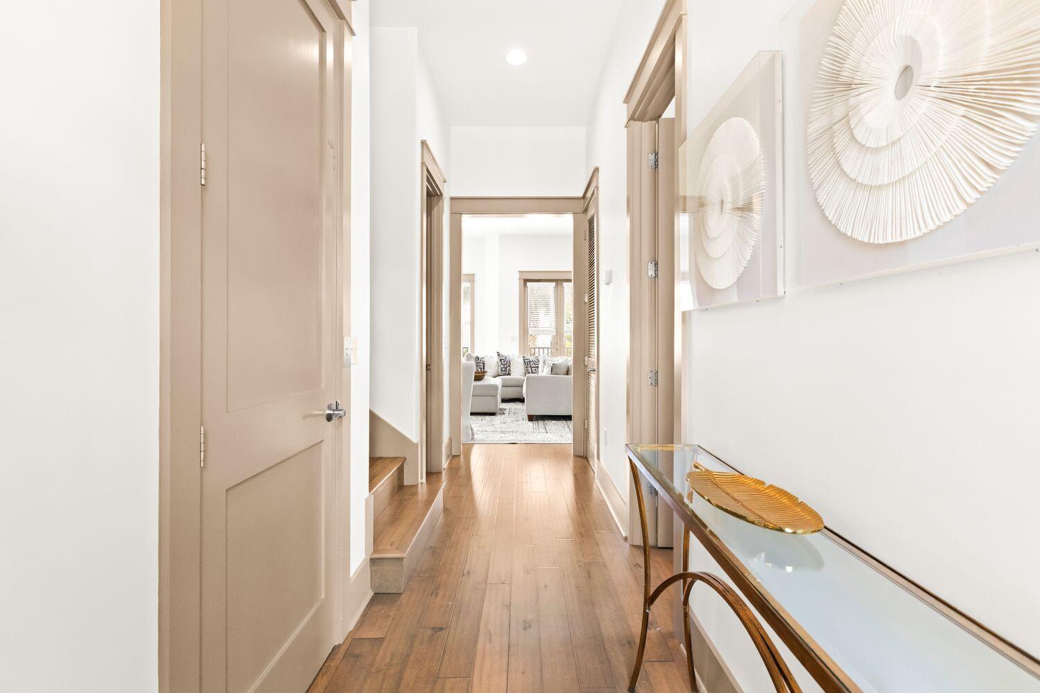 178 Woodward Drive Santa Rosa Beach, FL 32459 - Photo 15 of 29 a view of a hallway with wooden floor and staircase