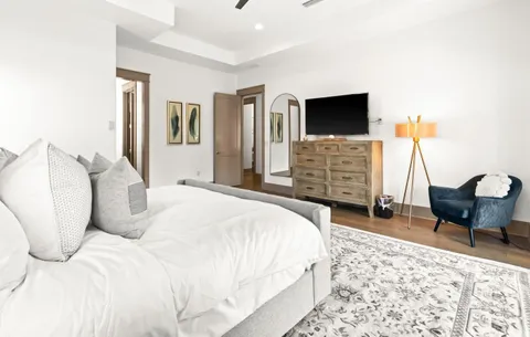 a bedroom with a bed and flat screen tv