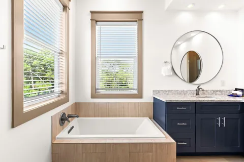 a bath tub sitting next to a window