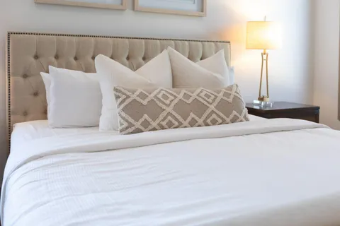 a bedroom with a bed and a night stand