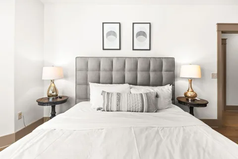 a bedroom with a bed and lamp on table