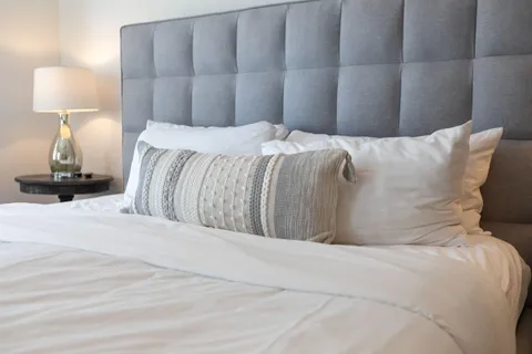 a bedroom with a bed and a lamp