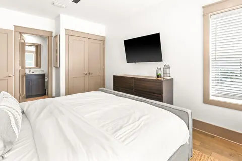 a bedroom with a bed and a flat screen tv