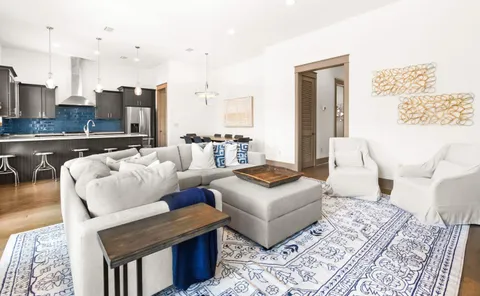 a living room with furniture and a rug