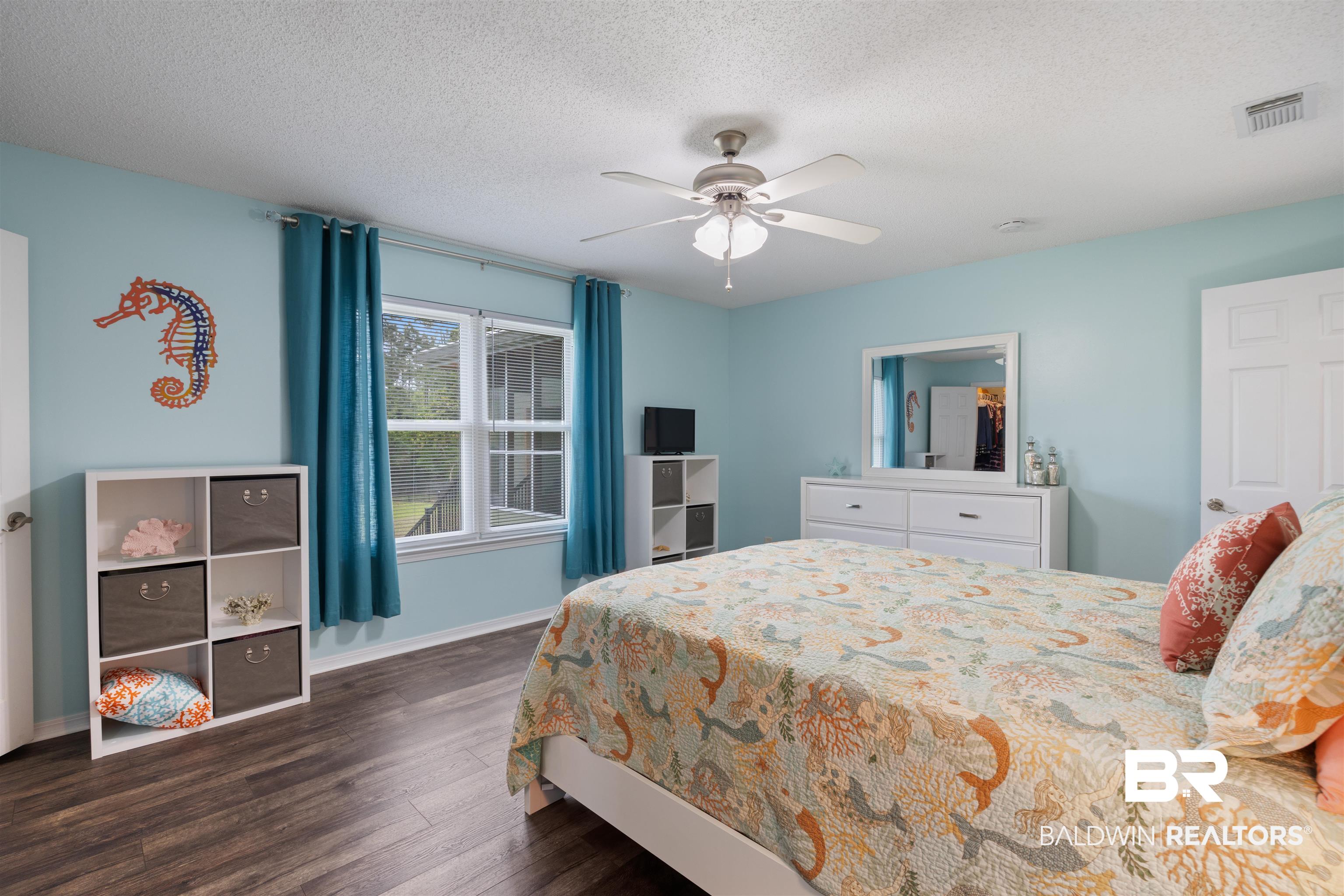 9771 Clarke Ridge Road Foley, AL 36535 - Photo 53 of 72 Bedroom featuring a textured ceiling, a ceiling fan, and baseboards.