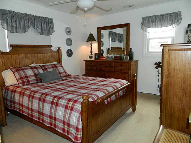 552 Country Club Road Washington, PA 15301 - Photo 14 of 25 Master Bedroom. The master bedroom is spacious with two windows. Neutral beige carpet and walls accent the room.