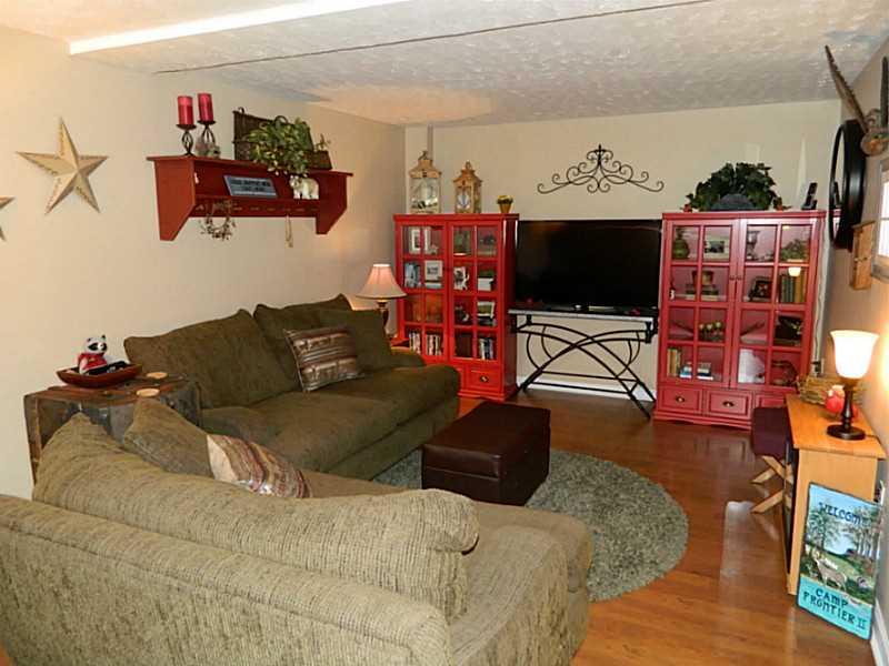 552 Country Club Road Washington, PA 15301 - Photo 19 of 25 Family Room. The lower level family room has laminate flooring and light beige paint.