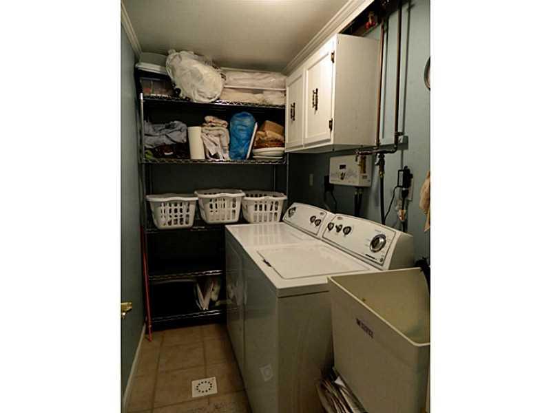 552 Country Club Road Washington, PA 15301 - Photo 23 of 25 Other. The laundry room is fit with a station tub and white utility cabinets above the washer and dryer (washer and dryer are not included in the sale).