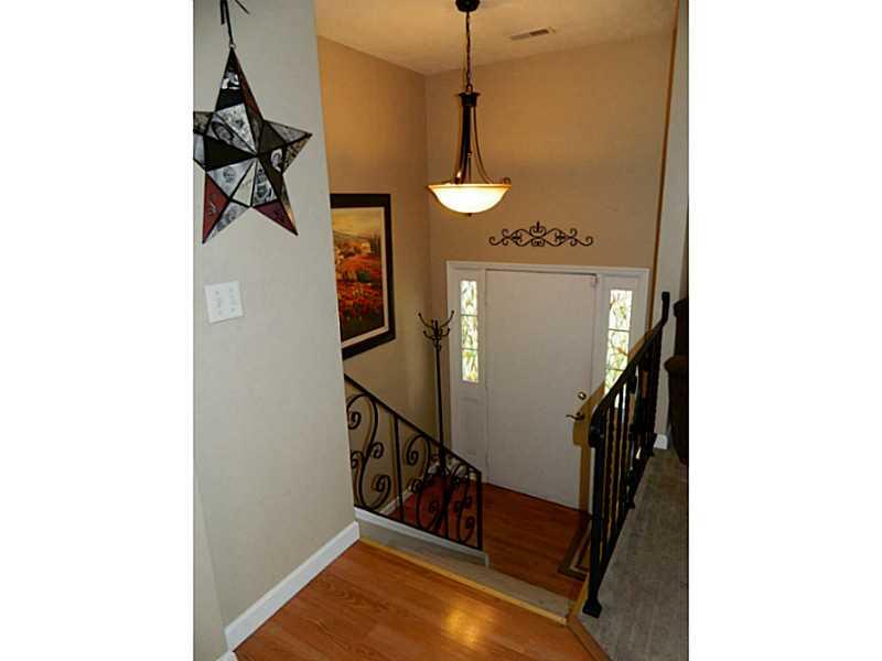 552 Country Club Road Washington, PA 15301 - Photo 5 of 25 Entry/Foyer. The entry is inviting with iron railings, laminate flooring and neutral paint.