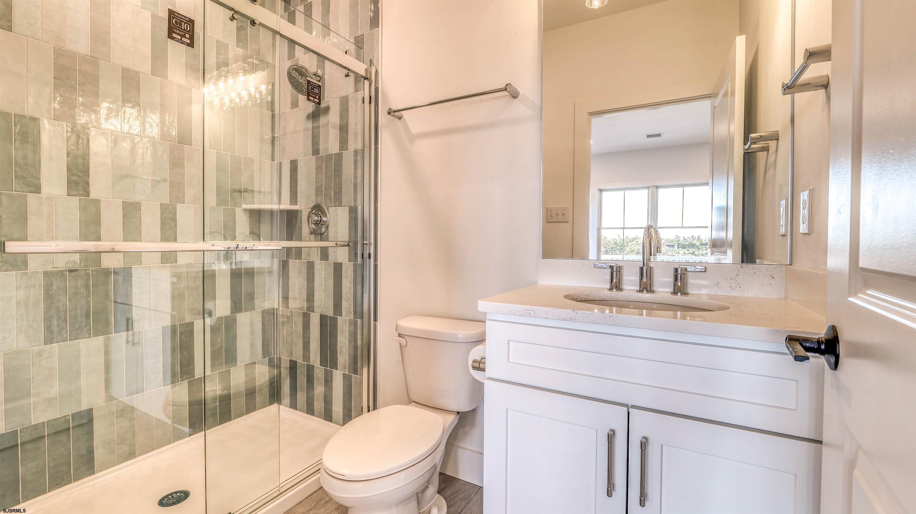15 Creek Lane Linwood, NJ 08221 - Photo 15 of 50 a bathroom with a sink a toilet a glass door and shower