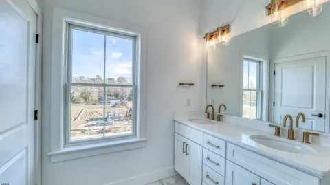 a bathroom with 2 sink and a mirror