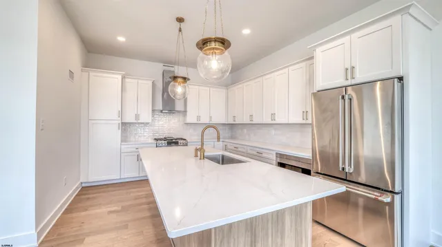 a kitchen with stainless steel appliances a refrigerator sink and microwave
