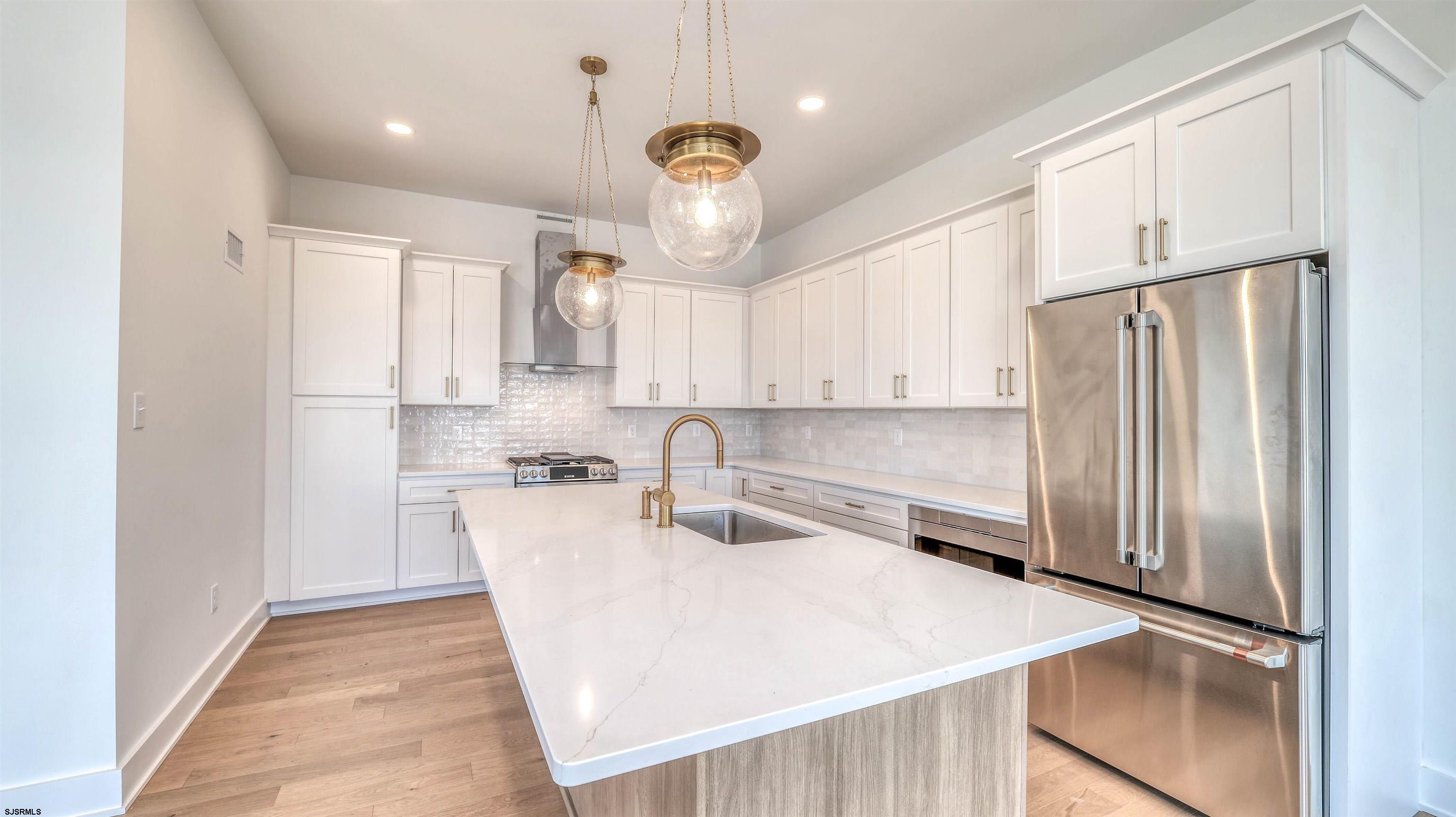 15 Creek Lane Linwood, NJ 08221 - Photo 26 of 50 a kitchen with stainless steel appliances a refrigerator sink and microwave