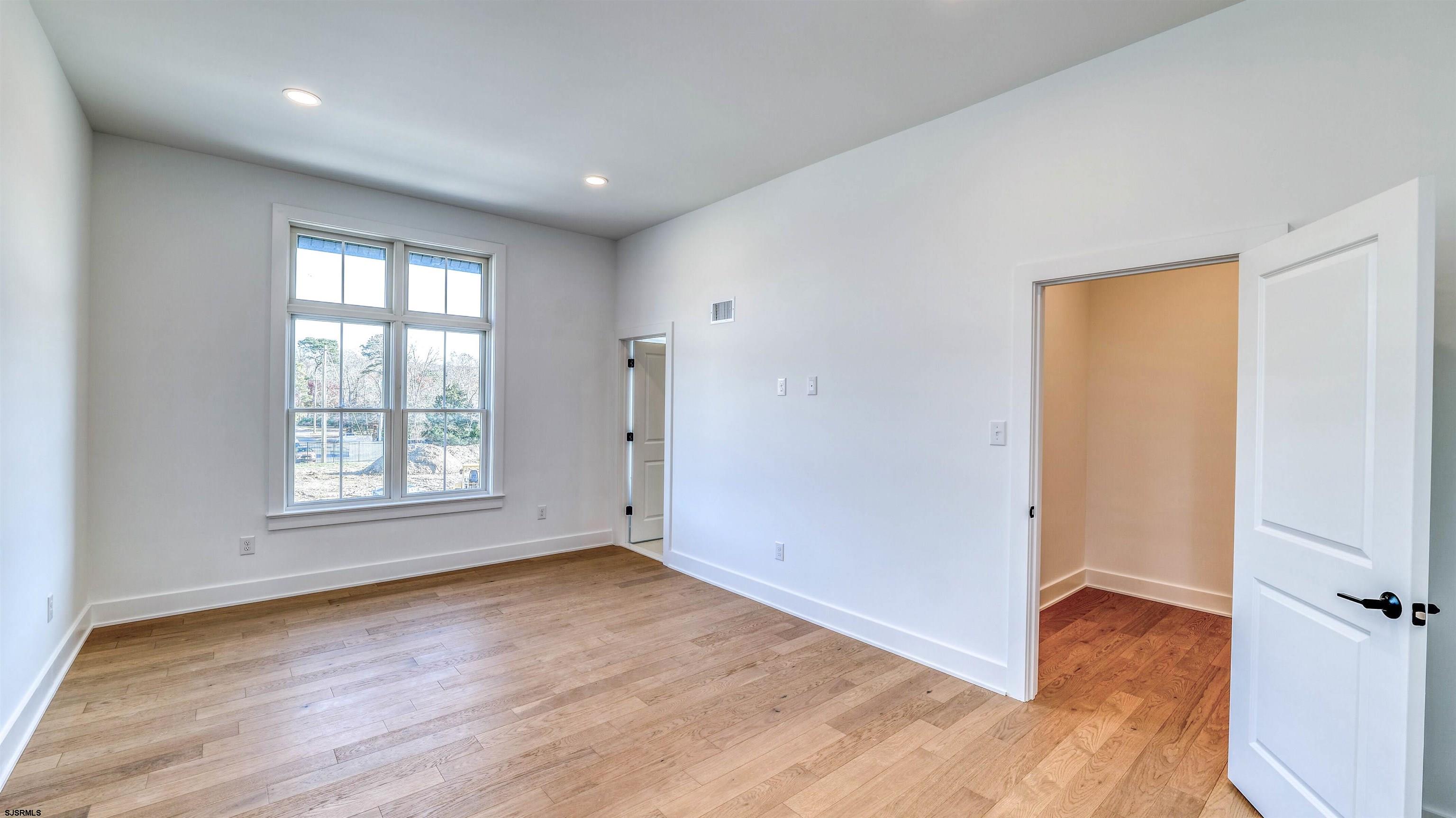 15 Creek Lane Linwood, NJ 08221 - Photo 31 of 50 an empty room with wooden floor and a window