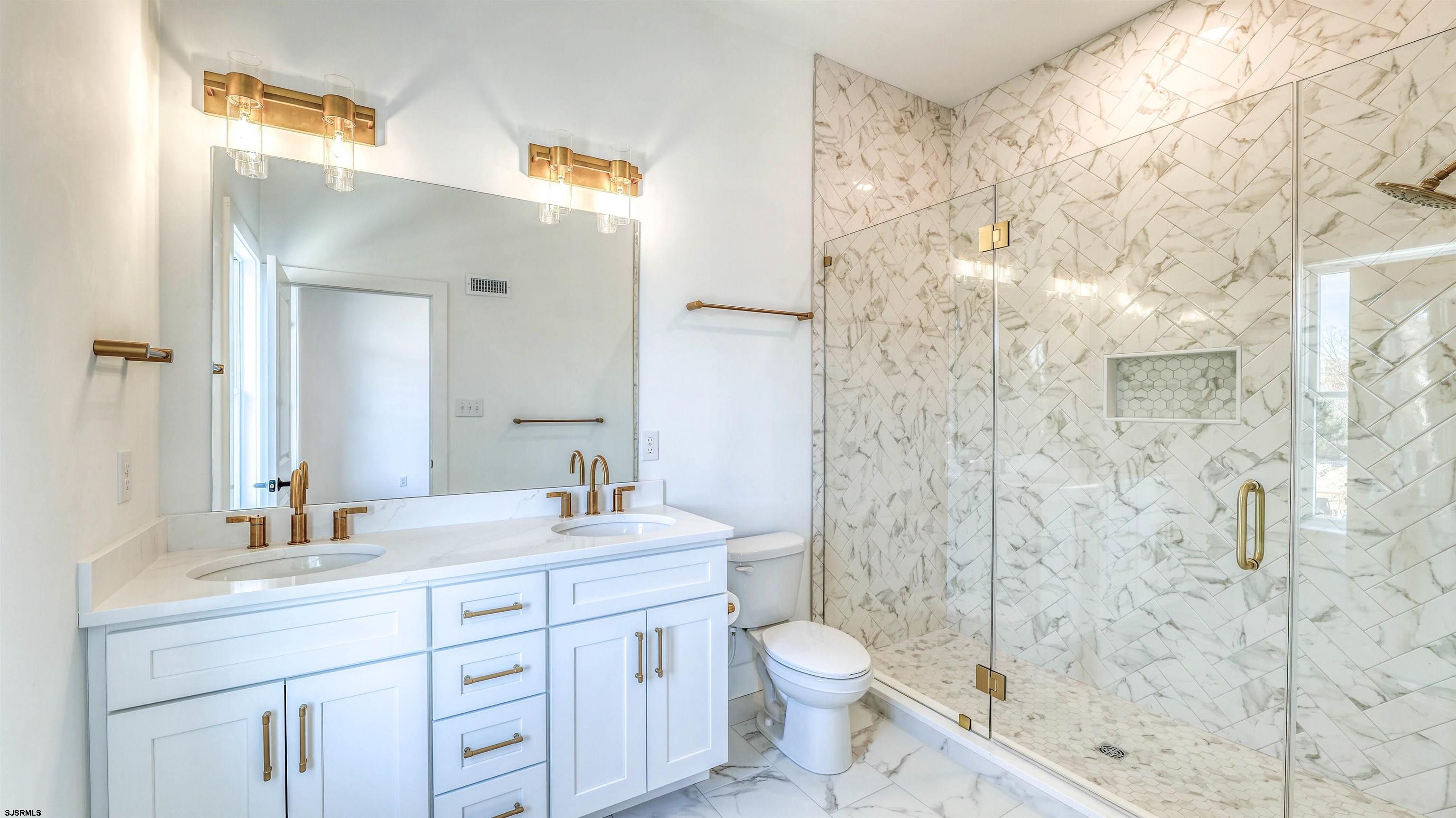 15 Creek Lane Linwood, NJ 08221 - Photo 34 of 50 a bathroom with a sink a toilet and shower