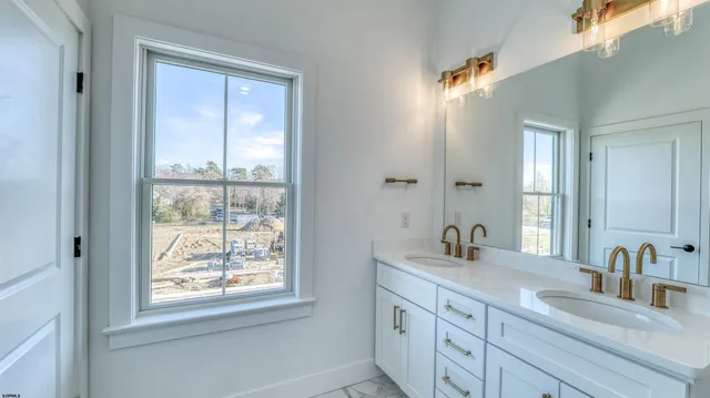a bathroom with 2 sink and a mirror