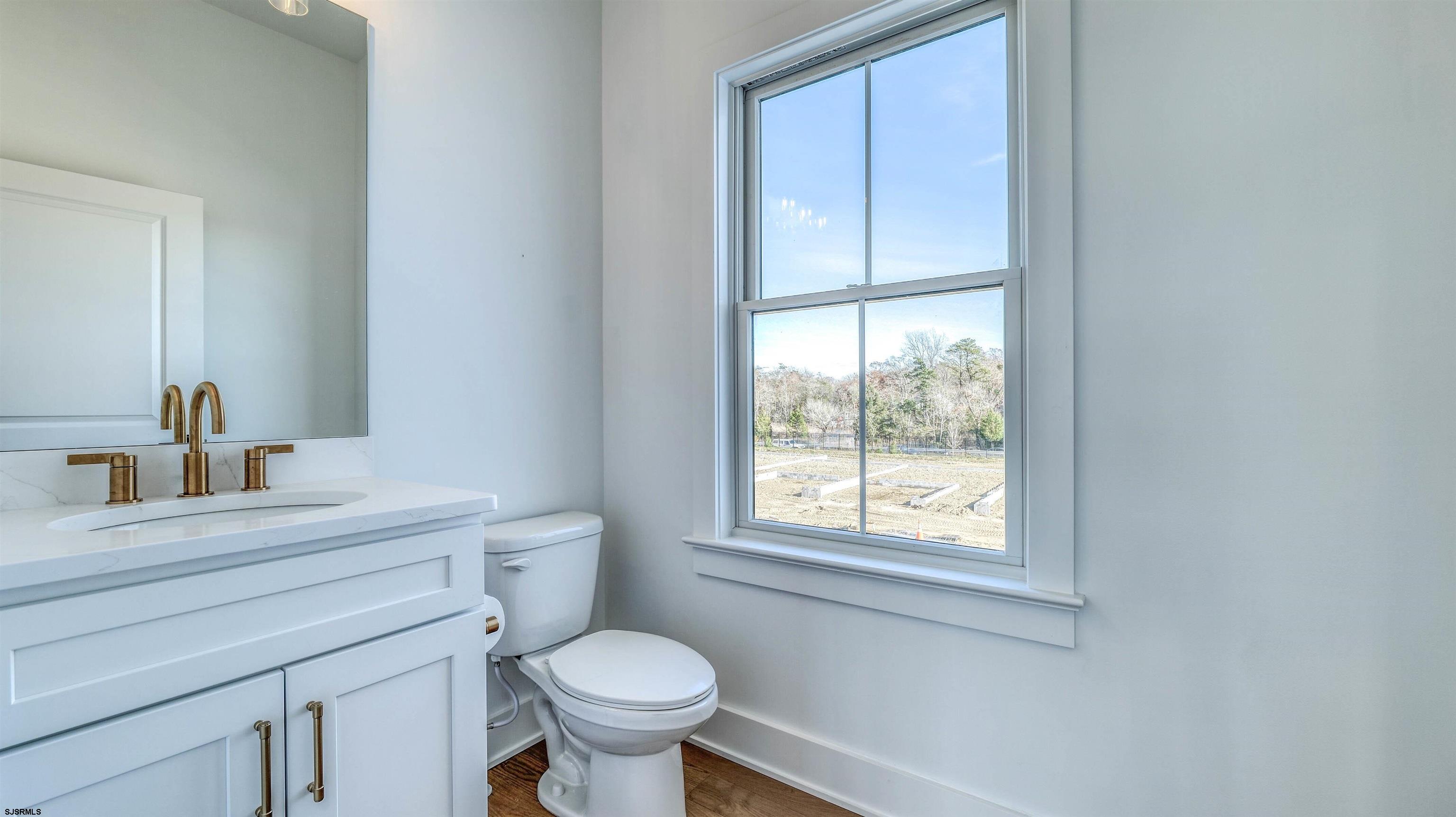 15 Creek Lane Linwood, NJ 08221 - Photo 38 of 50 a bathroom with a sink toilet a mirror and window