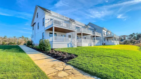 a view of a house with backyard and garden
