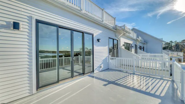 a view of a balcony with a floor to ceiling window and stairs