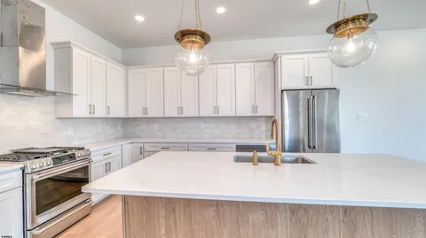 a kitchen with a sink a stove and cabinets