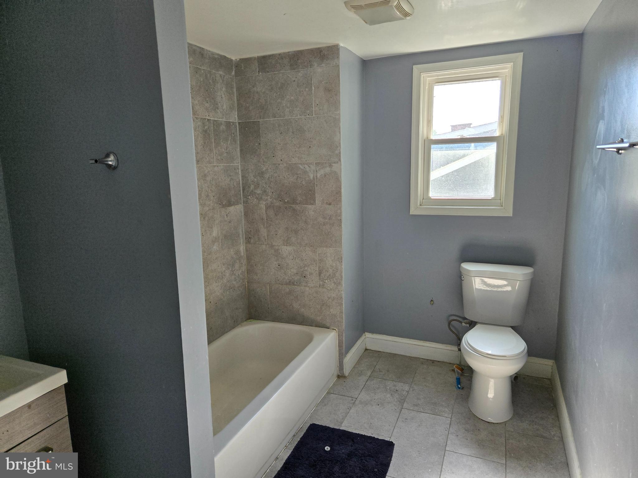 3811 Barrington Road Baltimore, MD 21215 - Photo 44 of 50 a bathroom with a toilet and a bathtub