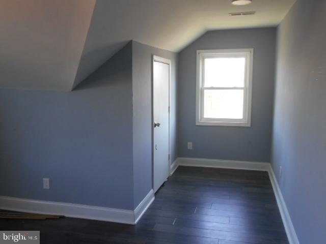 3811 Barrington Road Baltimore, MD 21215 - Photo 9 of 50 an empty room with wooden floor and windows