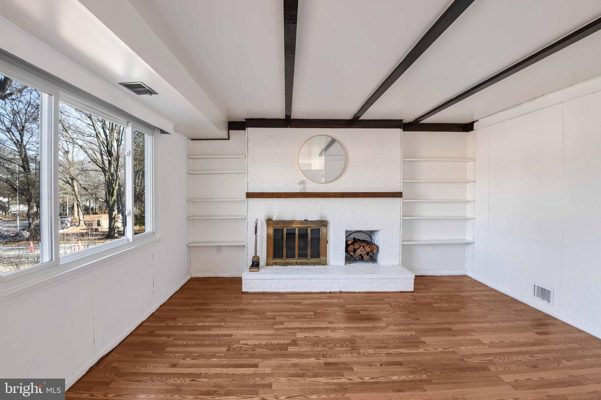 8310 Nightingale Drive Greenbelt, MD 20770 - Photo 11 of 27 a view of a livingroom with a fireplace and window