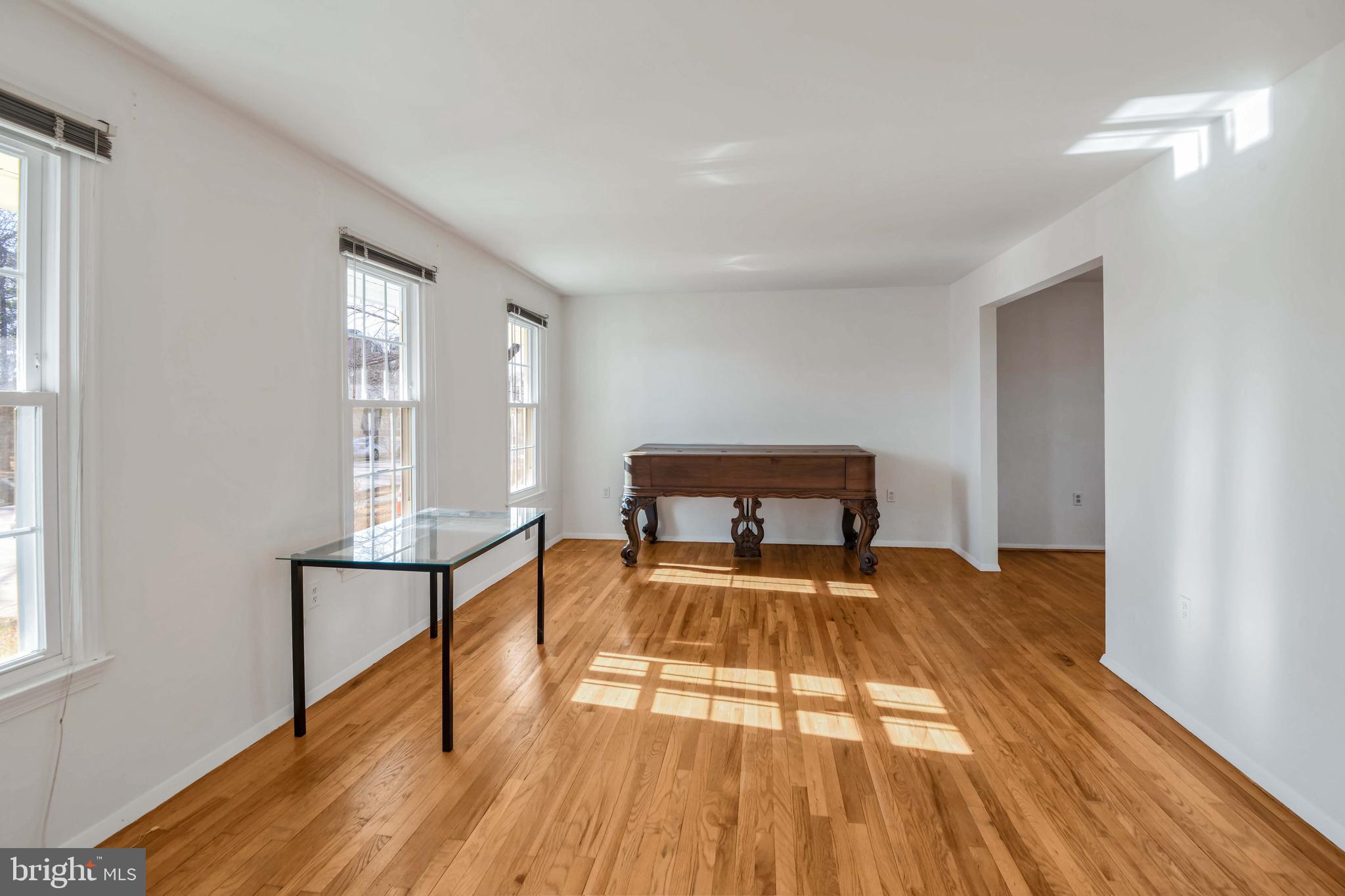 8310 Nightingale Drive Greenbelt, MD 20770 - Photo 3 of 27 a view of a bedroom with a bed and wooden floor