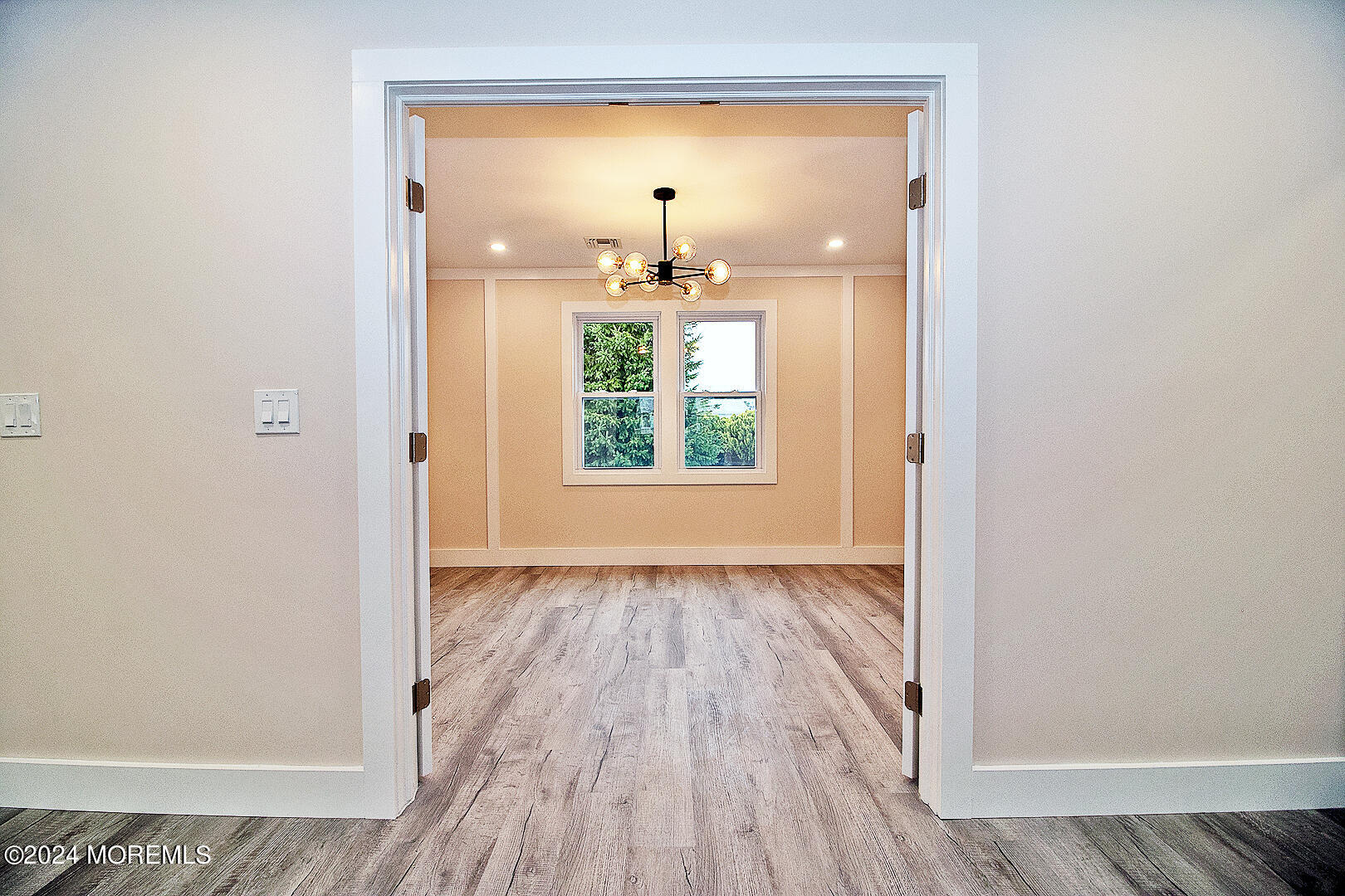 9 Mapleton Road Toms River, NJ 08757 - Photo 31 of 58 an empty room with wooden floor chandelier and windows