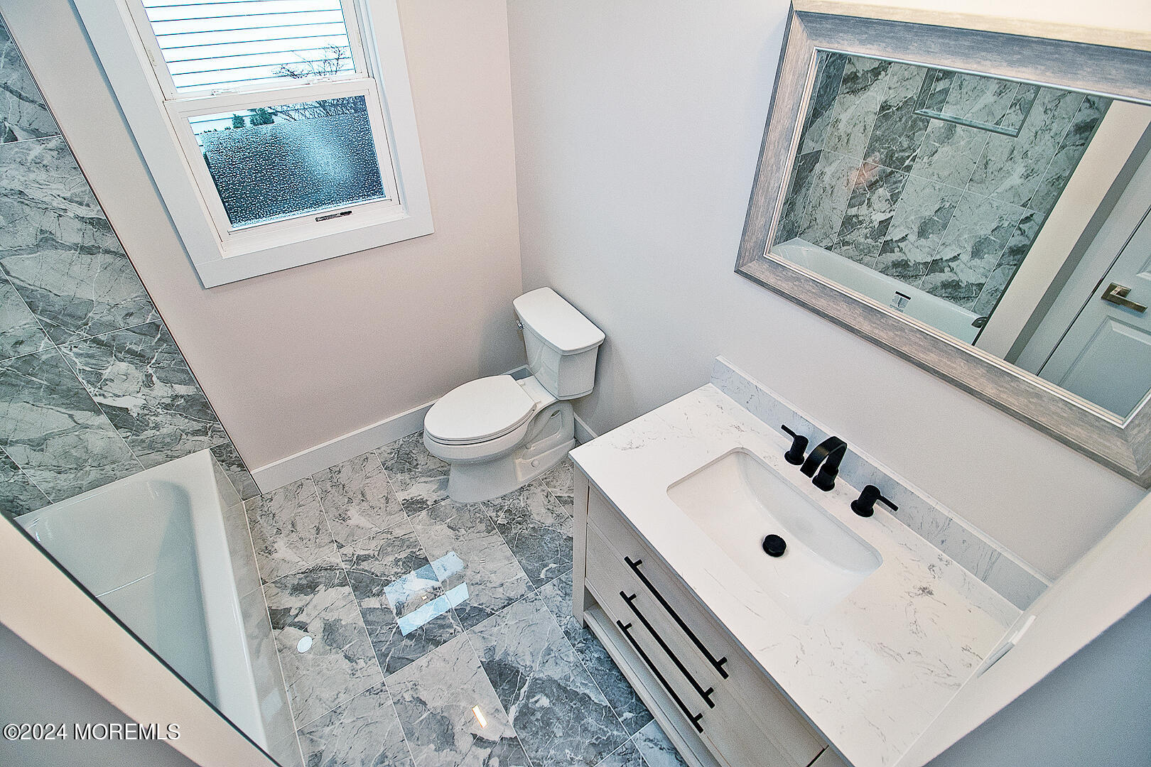 9 Mapleton Road Toms River, NJ 08757 - Photo 39 of 58 a bathroom with a sink and a mirror