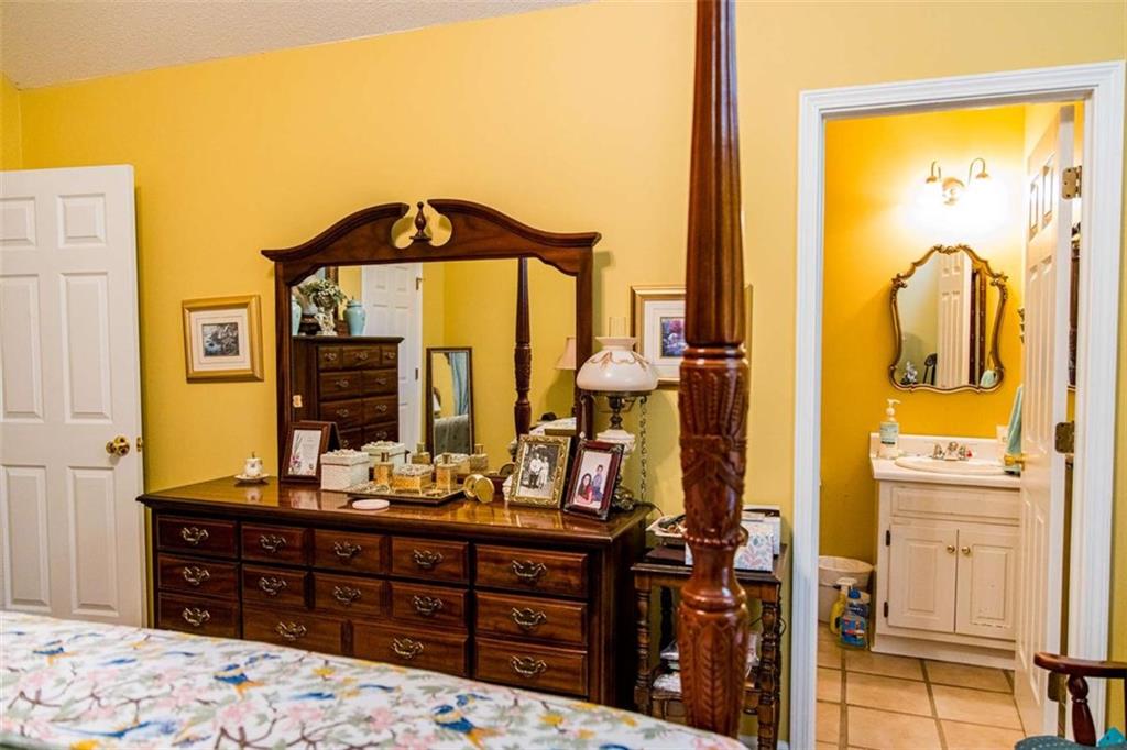 106 Eden Drive Northwest Rome, GA 30165 - Photo 14 of 23 a bedroom with a bed and dresser with mirror