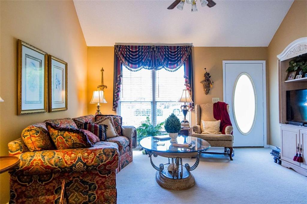 106 Eden Drive Northwest Rome, GA 30165 - Photo 2 of 23 a living room with furniture a rug and a large window