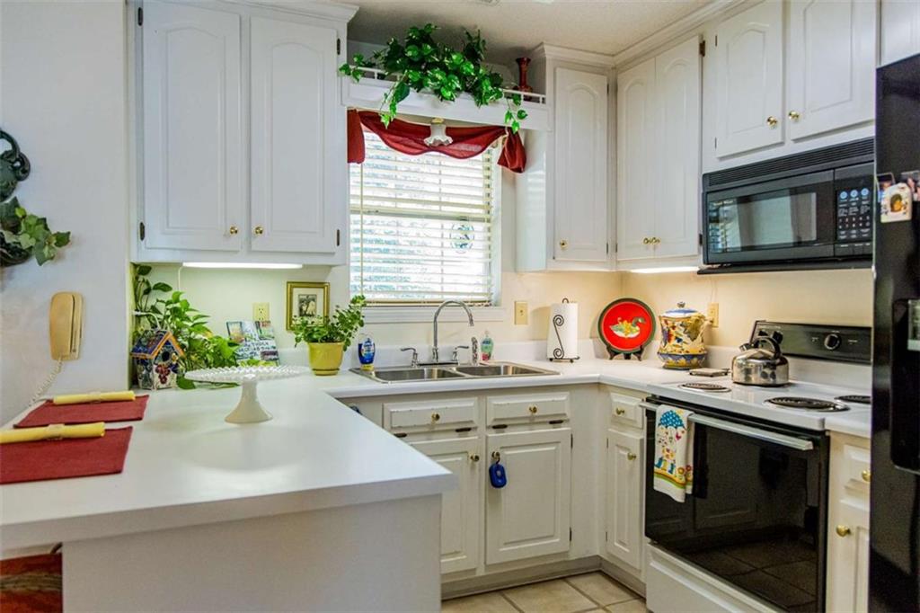 106 Eden Drive Northwest Rome, GA 30165 - Photo 5 of 23 a kitchen with stainless steel appliances granite countertop a sink and a microwave