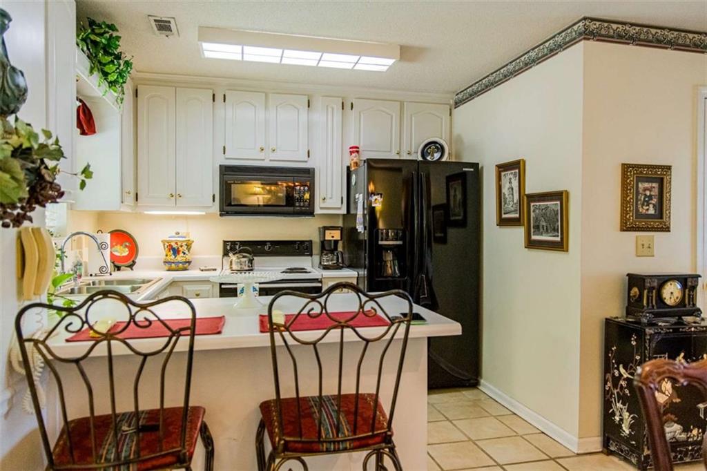 106 Eden Drive Northwest Rome, GA 30165 - Photo 6 of 23 a kitchen with stainless steel appliances granite countertop a refrigerator and microwave