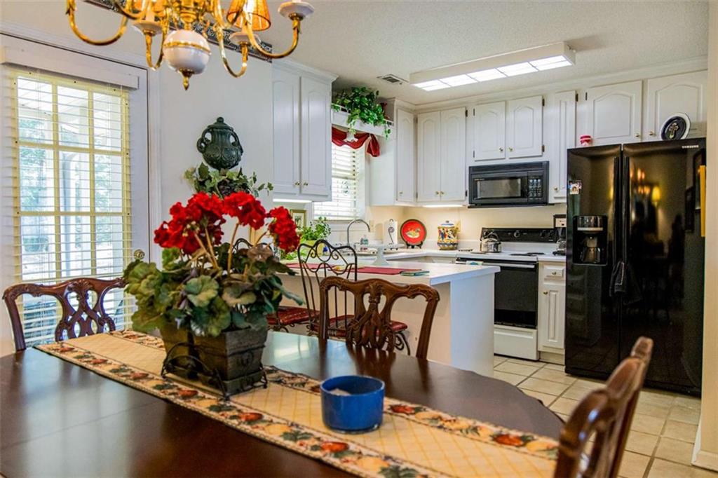 106 Eden Drive Northwest Rome, GA 30165 - Photo 7 of 23 a kitchen with a refrigerator and a table