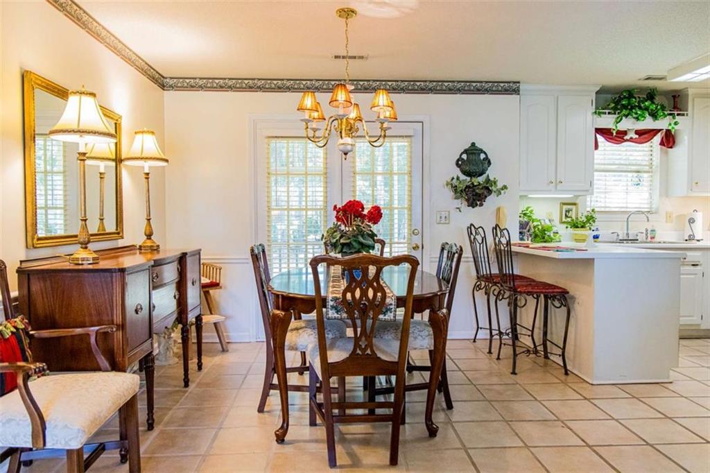106 Eden Drive Northwest Rome, GA 30165 - Photo 9 of 23 a view of a dining room with furniture and chandelier