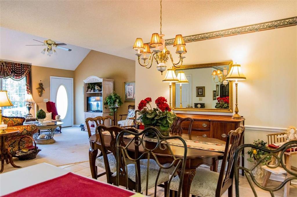 106 Eden Drive Northwest Rome, GA 30165 - Photo 10 of 23 a view of a dining room and livingroom with furniture wooden floor a chandelier
